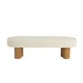 59-inch end-of-bed bench upholstered in natural cream boucle fabric with a rounded rectangular cushion and low-profile coastal-contemporary silhouette supported by chunky solid wood cylindrical legs.