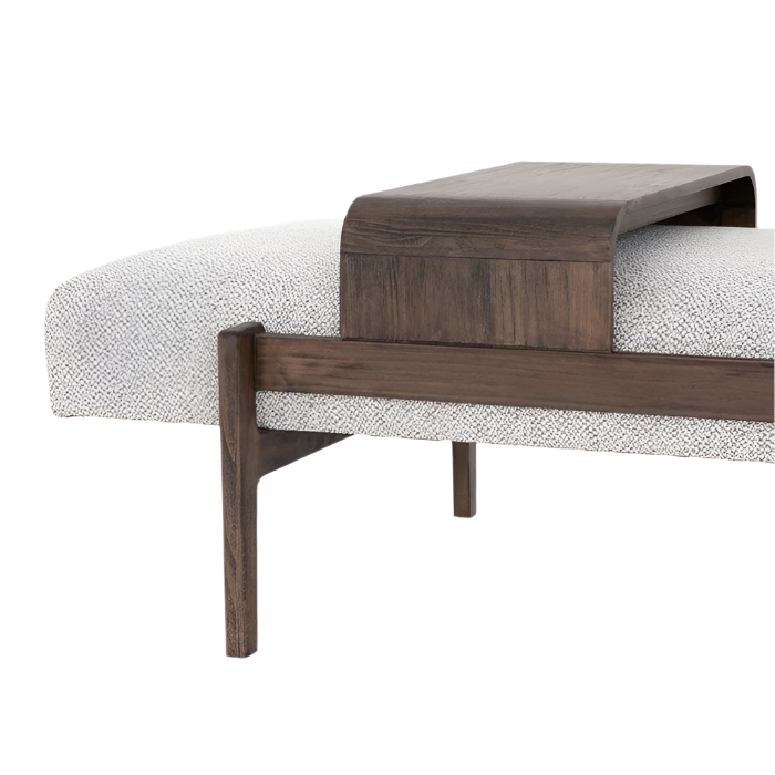 Close-up of an off-white boucle upholstered bench seat with a dark stained solid wood frame and curved wood tray, highlighting tapered legs, visible wood grain, and contemporary coastal styling.