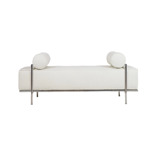 White upholstered end-of-bed bench with two cylindrical bolster pillows, thick cushioned seat and slim polished metal frame and legs in a modern, minimalist design.