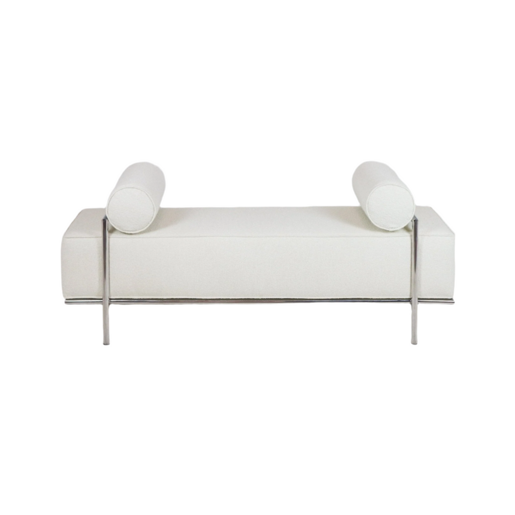 59-inch white fabric upholstered end-of-bed bench with two cylindrical bolster cushions and a polished stainless-steel frame and legs, shown on a white background.
