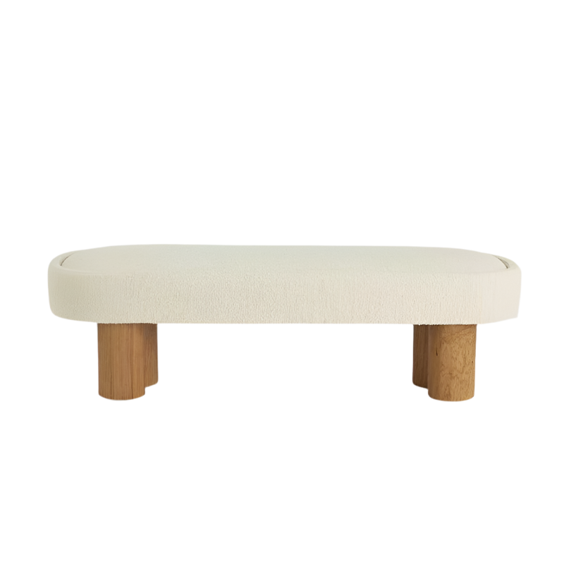 75-inch low-profile end-of-bed bench with cream boucle upholstery and solid natural wood cylindrical legs in a coastal-contemporary modern style.