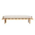 75-inch bench with a light beige bouclé cushion resting on a natural oak frame with cream strap webbing and round tapered legs, a low-profile coastal-contemporary end-of-bed design.