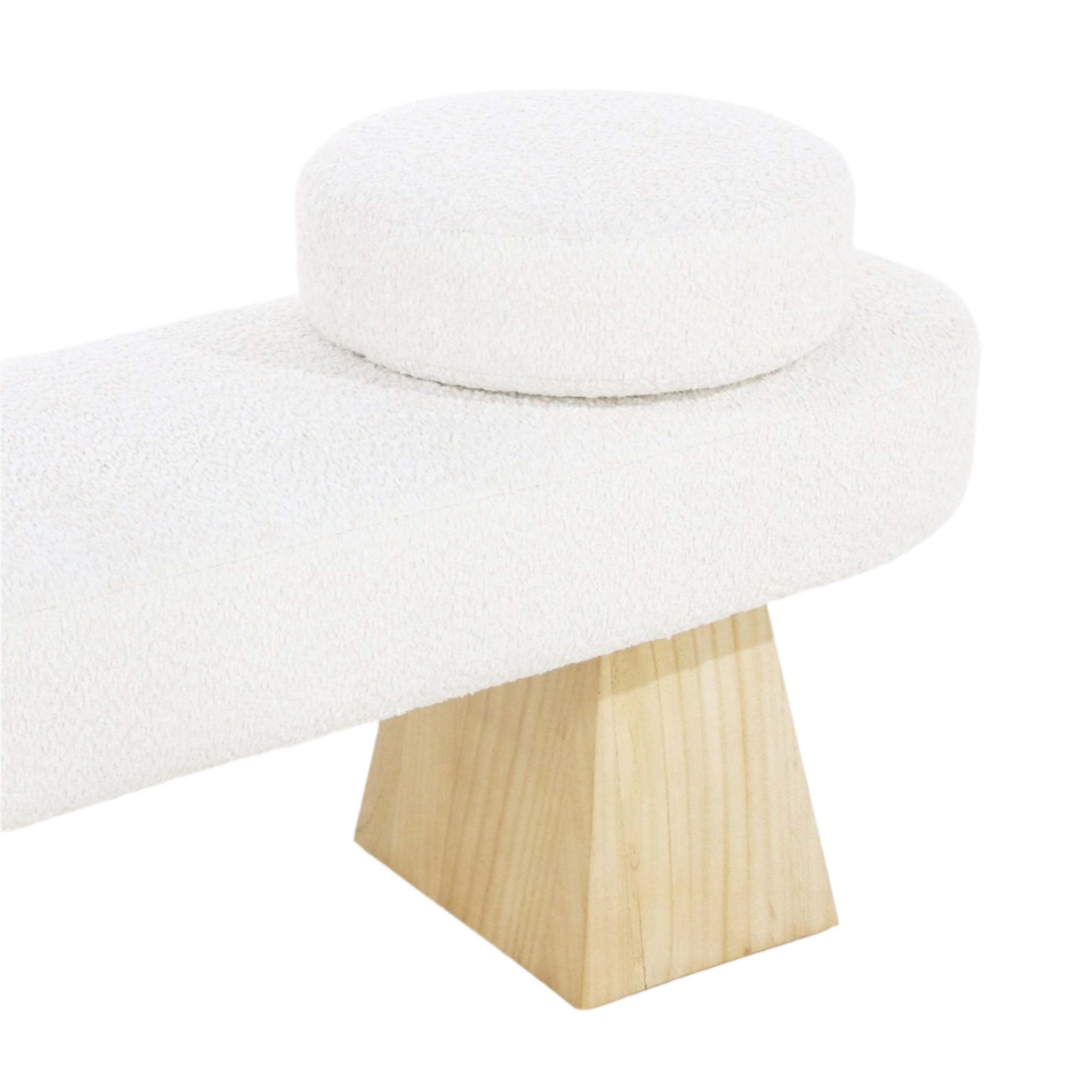 Close-up of a white boucle upholstered bench seat showing a round padded cushion and a tapered natural wood leg in a coastal-contemporary style.