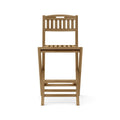 Front view of an armless folding teak outdoor bar stool with slatted seat and back, natural teak finish, integrated slatted footrest and coastal solid-wood construction.