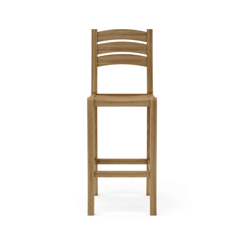 Front view of an armless teak outdoor bar stool with a three-slat curved ladder back, solid teak construction, square legs and two horizontal footrest bars in a natural teak finish.