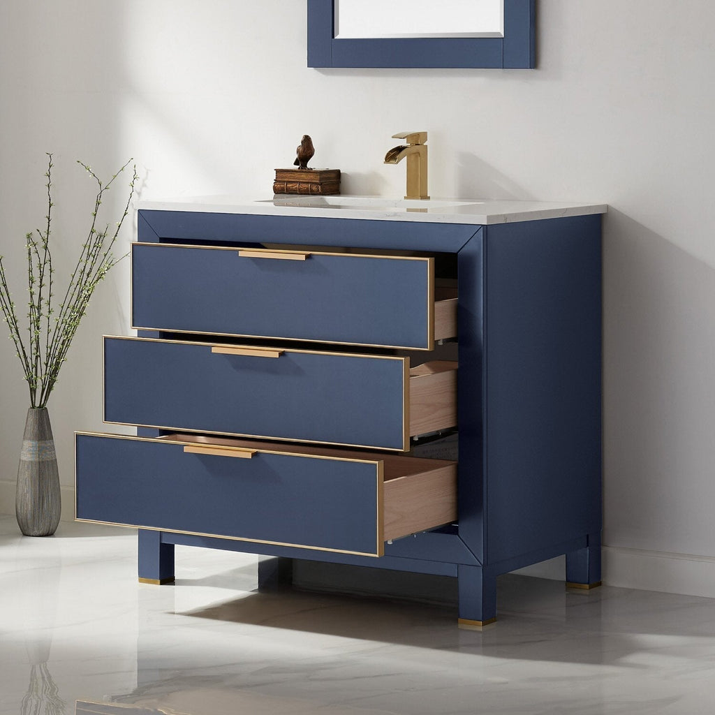 Freestanding modern 36-inch solid wood bathroom vanity with a white stone top and deep blue painted case; three soft-close drawers with gold trim and matching gold faucet, drawers partially open to show wood interiors.