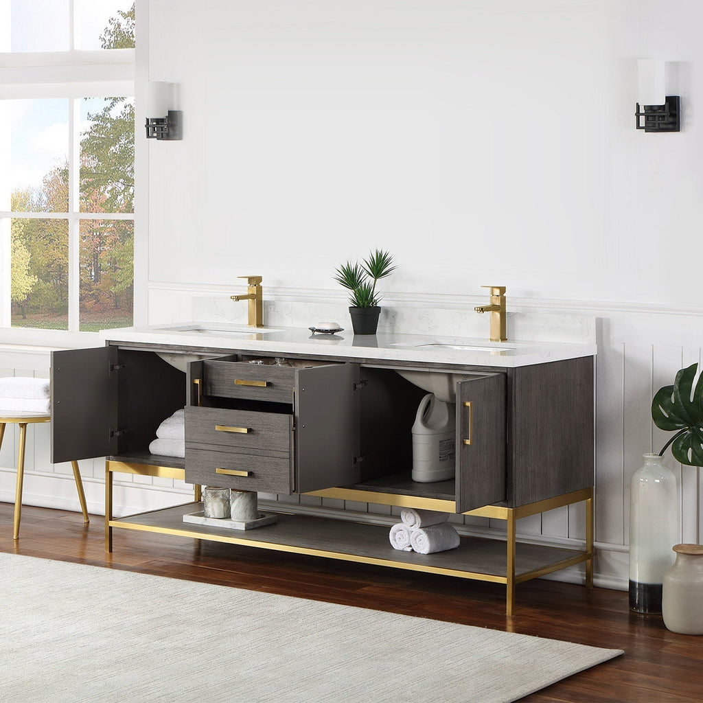 Modern solid wood 72-inch double-sink vanity in stone finish with white stone countertop, gold faucets and gold metal base; open cabinets reveal central drawers, lower shelf storage and rolled towels.