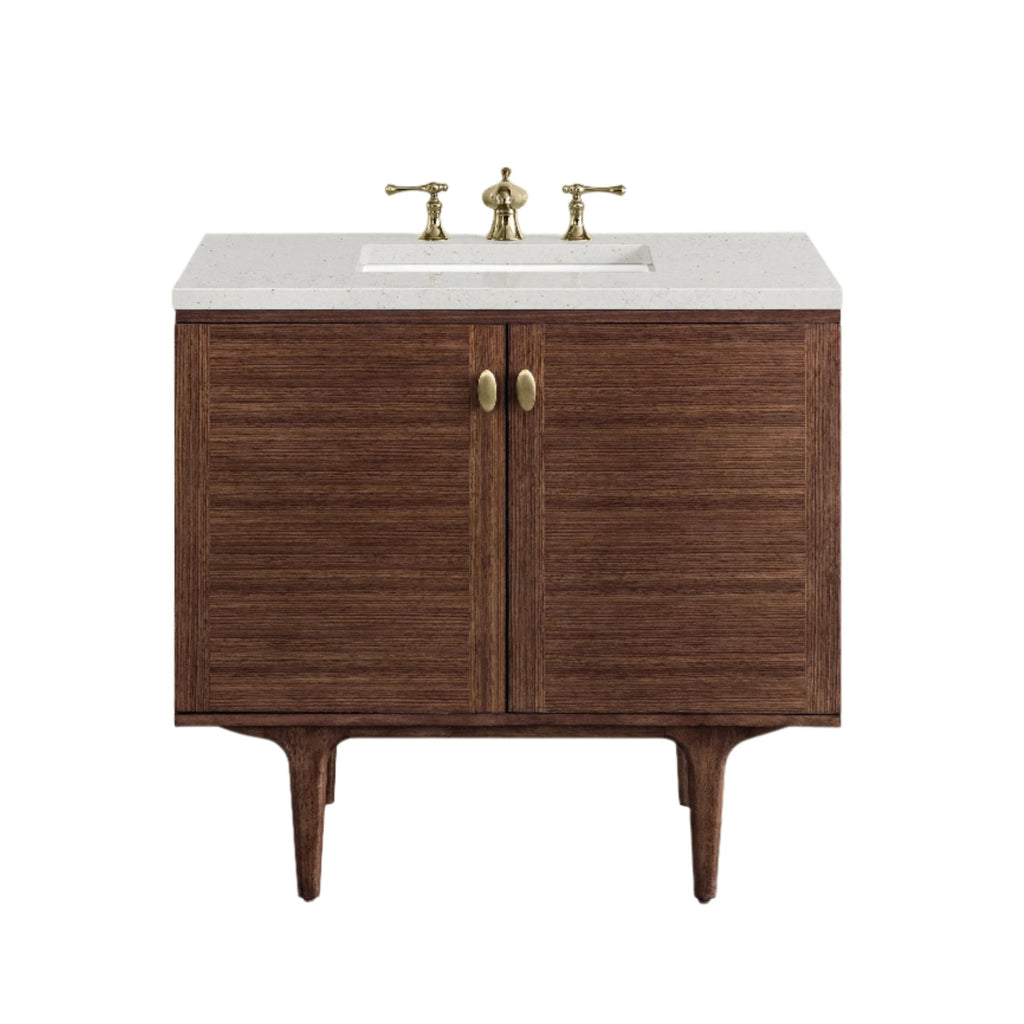 36-inch single-sink modern bathroom vanity in natural solid wood with a white stone countertop, integrated rectangular ceramic sink, brass faucet and oval brass knobs, raised on tapered mid-century style legs.