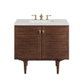 36-inch single-sink modern bathroom vanity in natural solid wood with a white stone countertop, integrated rectangular ceramic sink, brass faucet and oval brass knobs, raised on tapered mid-century style legs.