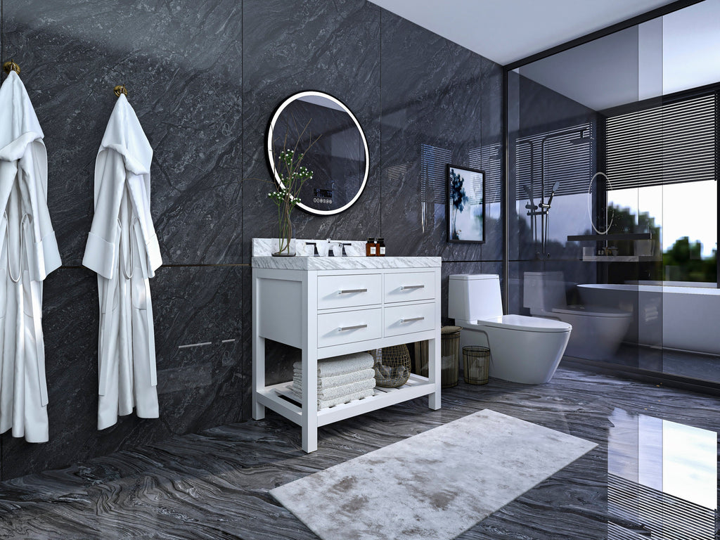 Modern solid wood freestanding 36-inch bathroom vanity in stone finish with marble top, single white ceramic sink, four drawers and open lower shelf with folded towels beneath a round mirror on dark stone walls.