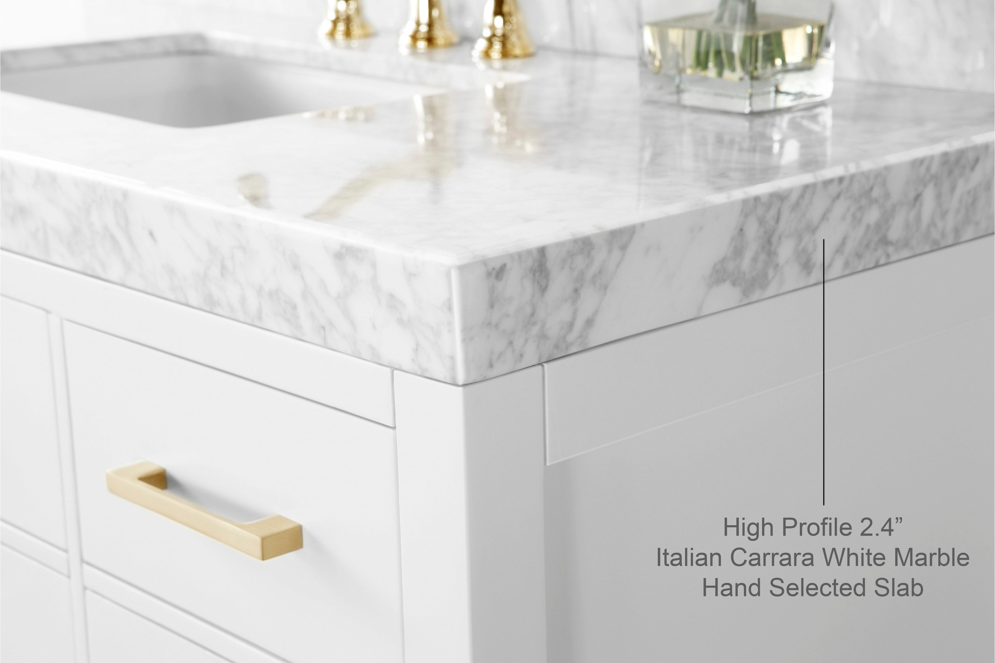 Close-up of a modern solid wood bathroom vanity corner featuring a high-profile 2.4” Italian Carrara white marble stone top, white painted cabinet front, brushed gold drawer pull and undermount ceramic sink.