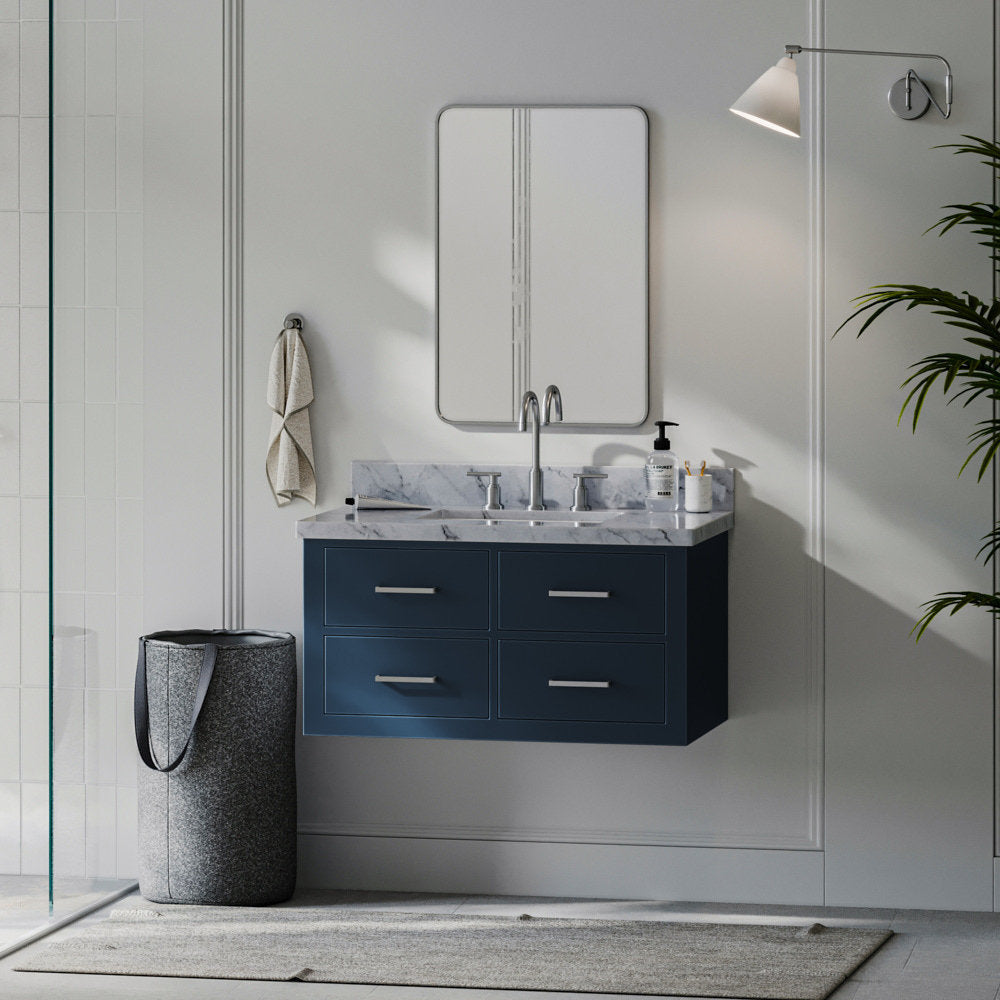 Wall-mounted 37-inch solid wood single-sink vanity with a stone marble top, deep navy painted cabinet, four drawers with metal pulls, chrome faucet, rectangular mirror and towel basket in a modern bathroom scene.