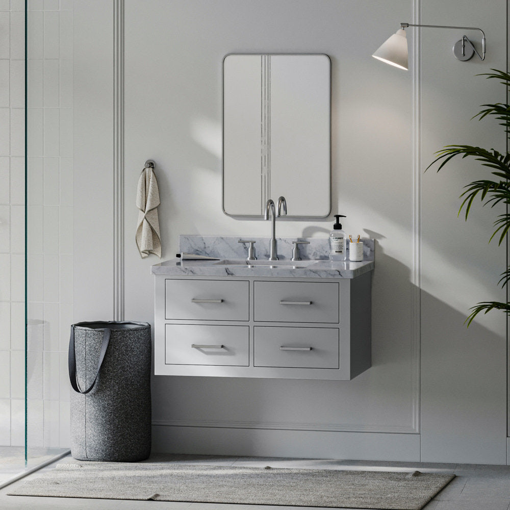 Wall-mounted modern 37-inch solid wood bathroom vanity in stone gray with a stone top and single undermount sink, brushed-nickel faucet, four drawers, rectangular mirror, wall sconce, towel hook and gray felt laundry basket.