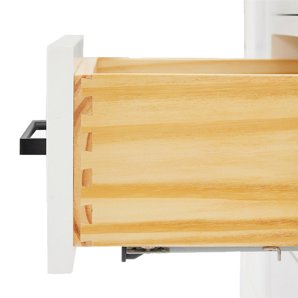 Close-up of a solid wood vanity drawer showing dovetail joints and natural wood grain, with a white-painted front panel, black rectangular handle and visible metal soft-close drawer slide.