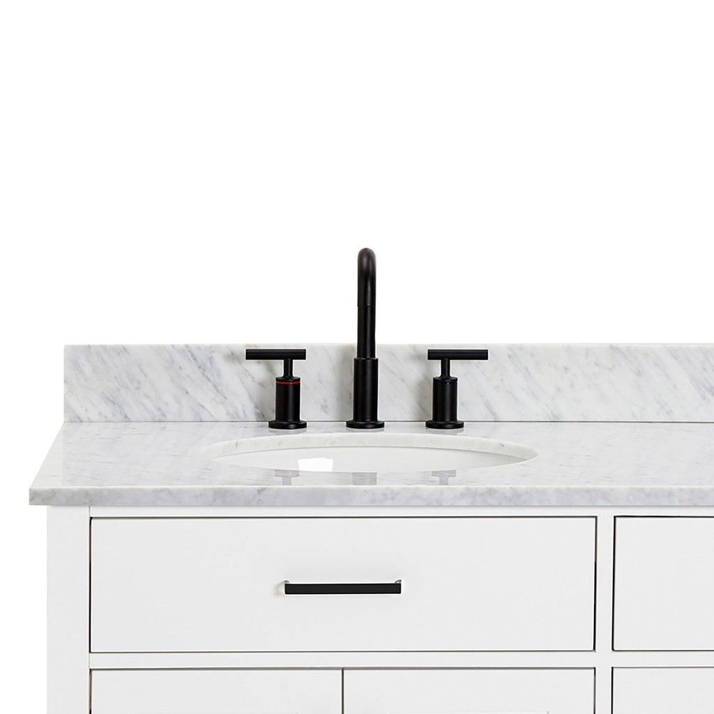 Front view of a white solid-wood bathroom vanity with light gray veined quartz countertop and backsplash, undermount ceramic sink, matte black widespread faucet and matching black drawer pull.