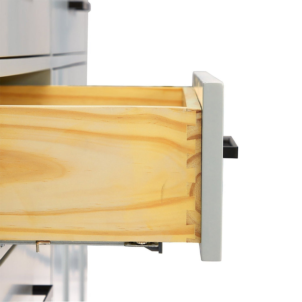 Close-up of a solid wood drawer showing dovetail joinery and natural light wood grain, with a gray painted front panel and matte-black handle, extended from a modern bathroom vanity.