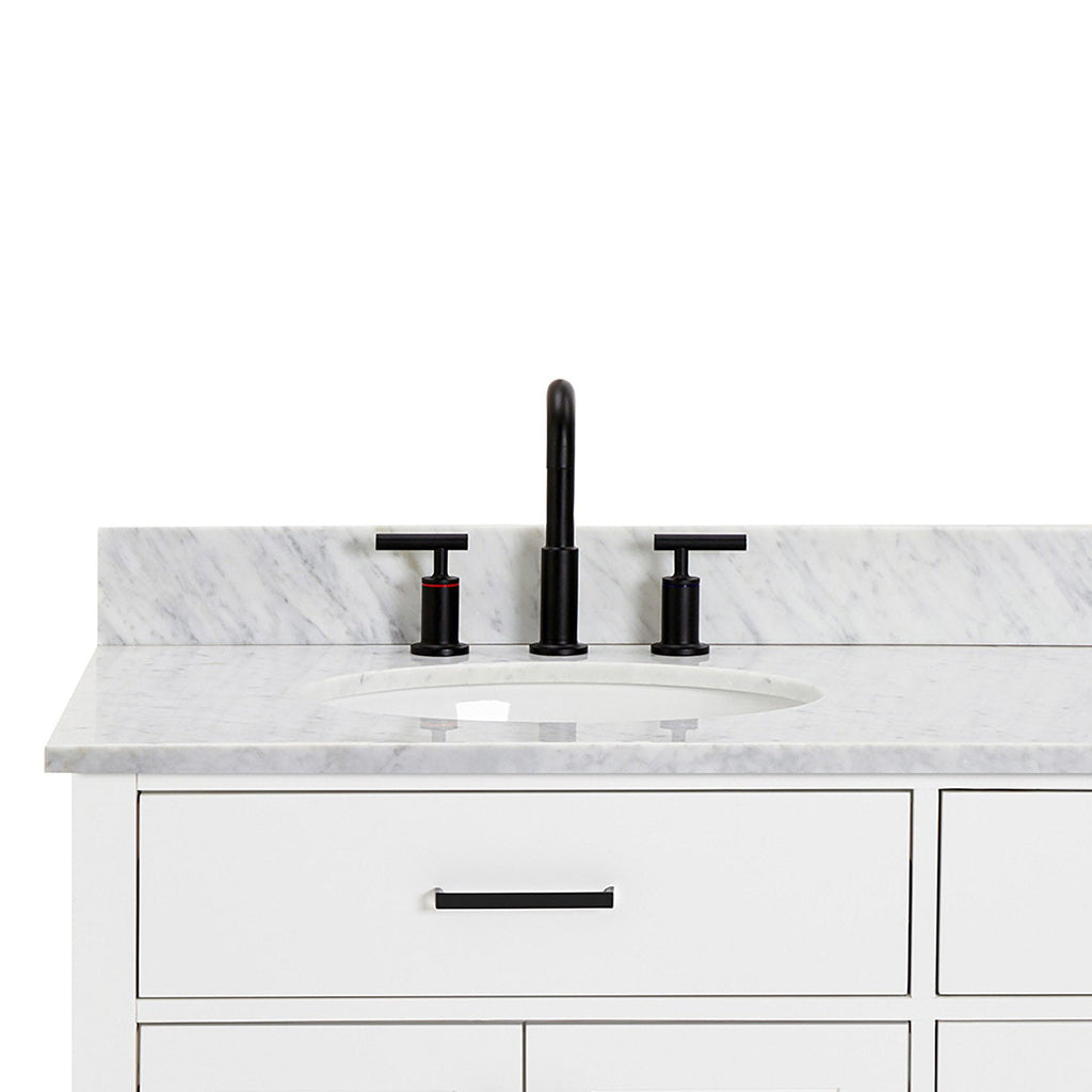 Front view of a white solid-wood bathroom vanity with light gray veined quartz countertop and backsplash, undermount ceramic sink, matte black widespread faucet and matching black drawer pull.