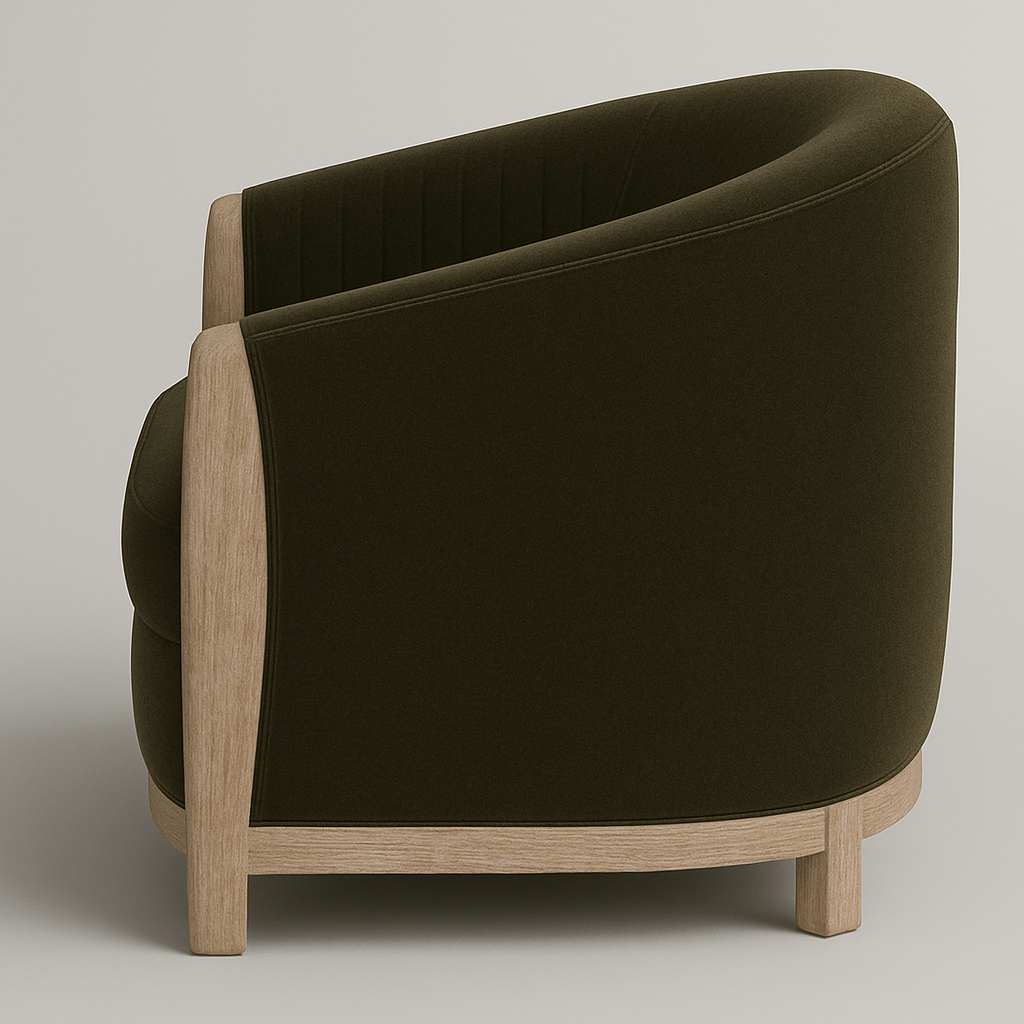 Rear three-quarter view of an olive velvet barrel accent chair with plush upholstery, natural wood frame and short square legs in a modern contemporary silhouette.