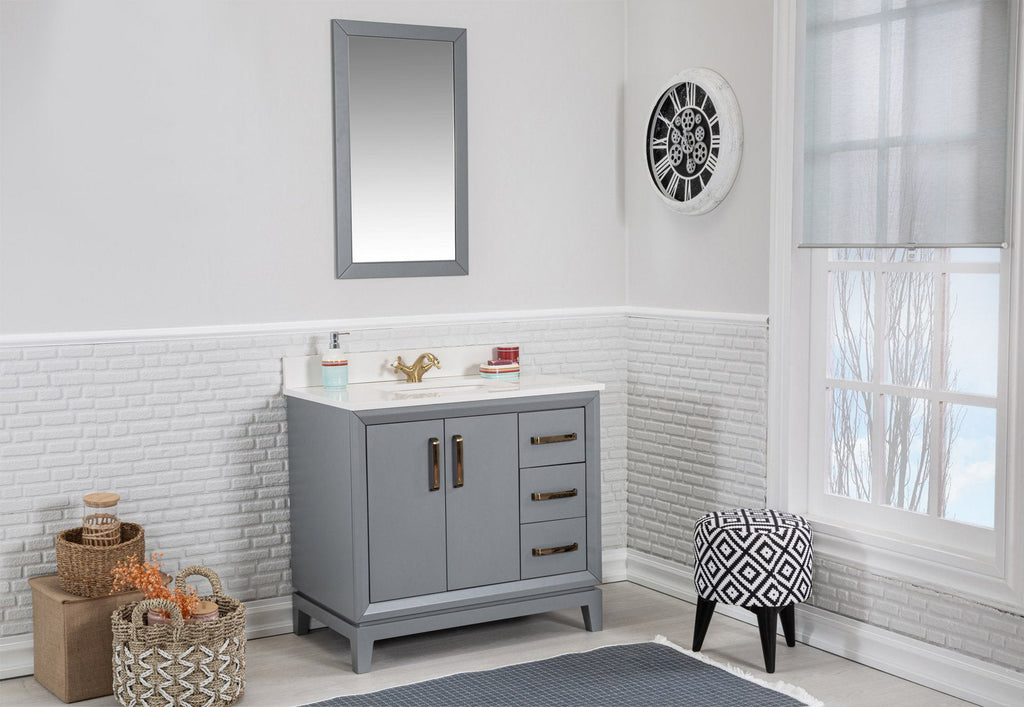 Freestanding modern gray solid wood bathroom vanity with white stone countertop and brass faucet, two doors and three drawers; rectangular mirror above, woven storage baskets to the left and a black-and-white patterned stool by the window.