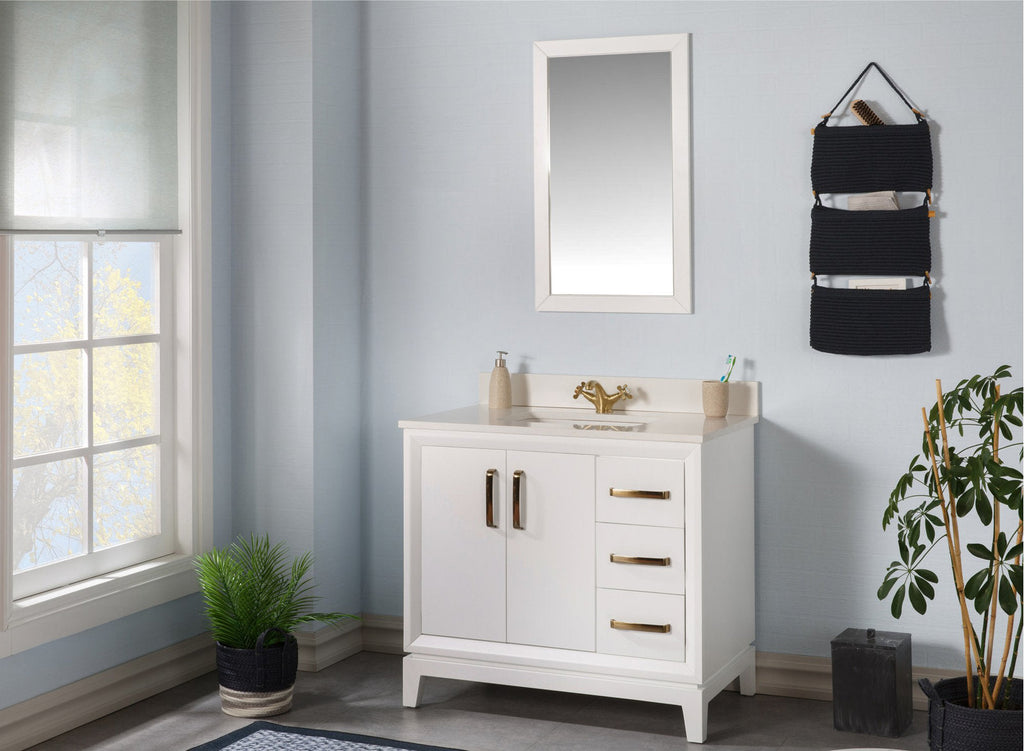 Modern freestanding solid wood single-sink bathroom vanity in white with a stone top, brass faucet and handles, two cabinet doors with three right-side drawers, shown with a framed mirror, wall organizer and plants.