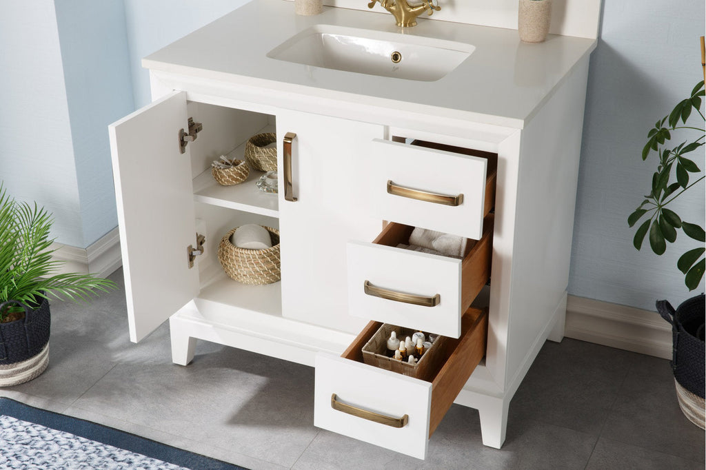 Modern white freestanding bathroom vanity with stone countertop and integrated ceramic sink; left cabinet door open showing woven baskets and three drawers open revealing wood interiors and brass handles.