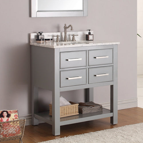 Freestanding modern gray solid-wood bathroom vanity with stone marble top and backsplash, single undermount sink, brushed-nickel faucet, four drawer fronts with horizontal metal pulls and lower shelf with basket and towels.