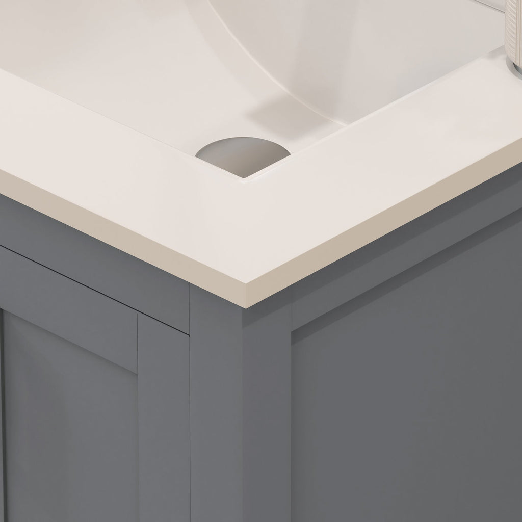 Close-up of a modern solid wood bathroom vanity corner showing a stone-colored countertop with integrated white ceramic sink and a gray wooden cabinet front with clean contemporary lines.