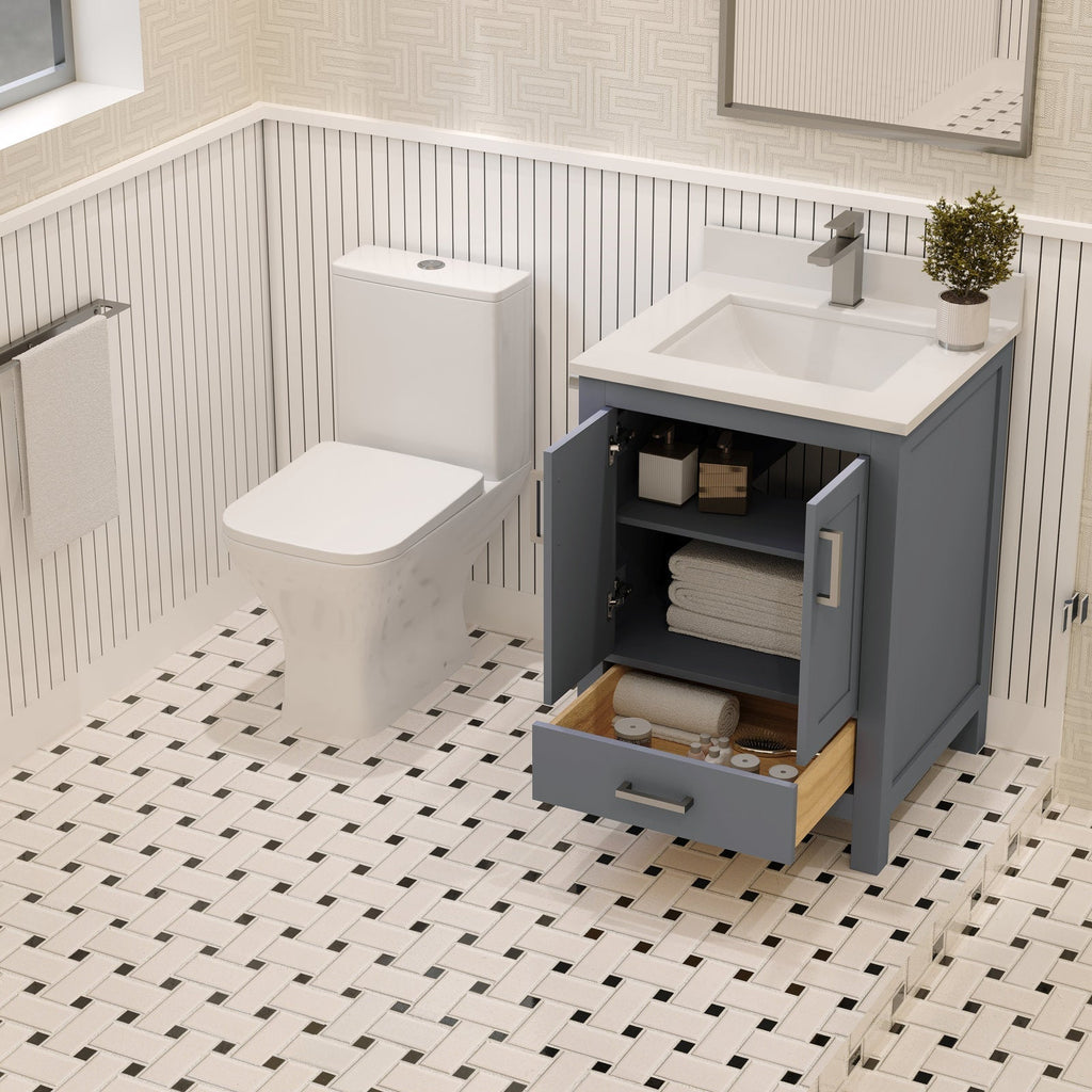 24-inch solid wood single-sink bathroom vanity in stone finish with a white stone top and ceramic sink, open cabinet and drawer showing towels and toiletries beside a modern toilet on patterned tile.
