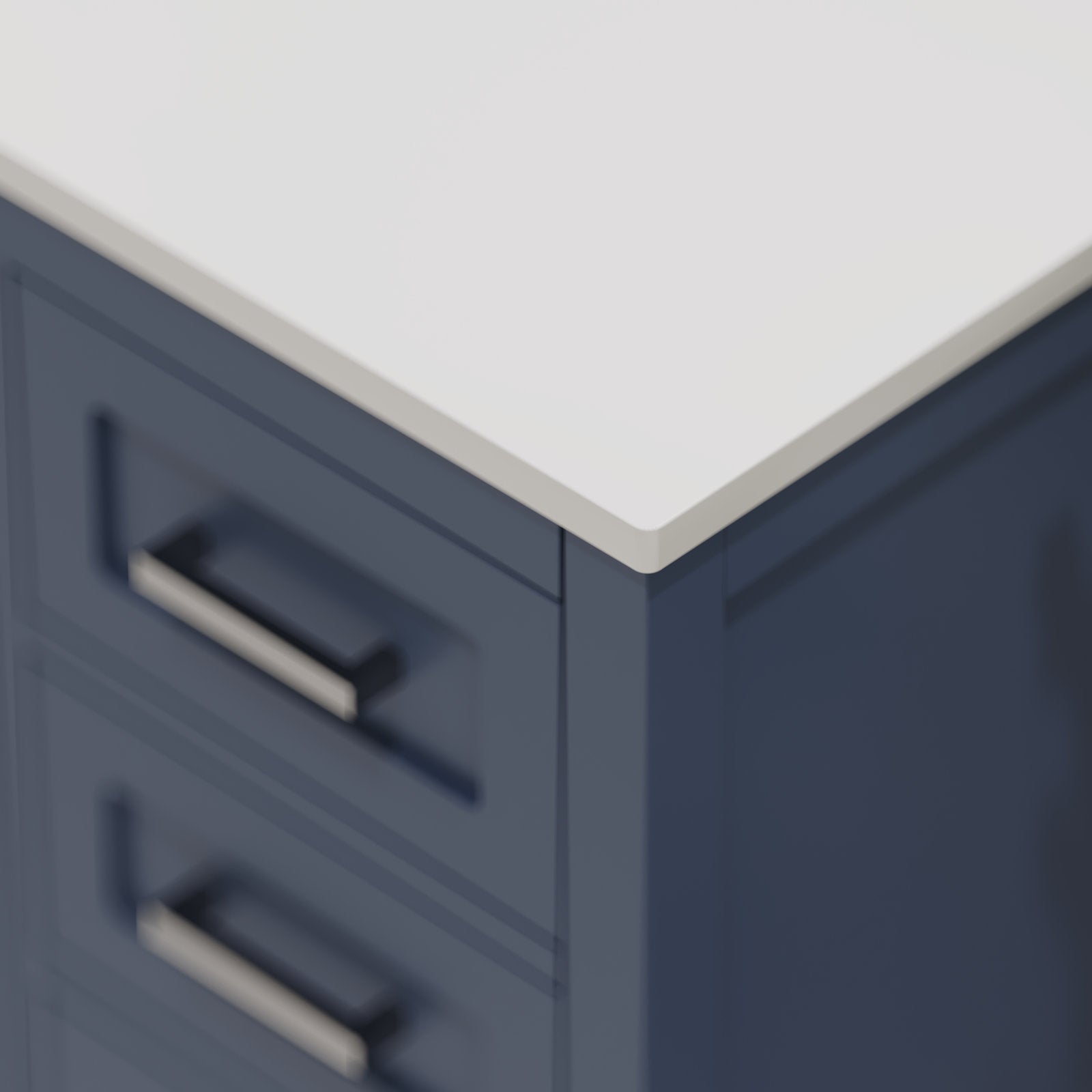 Close-up of a modern solid wood bathroom vanity corner with a stone white countertop, navy-blue wooden cabinet front, rectangular metal drawer pulls and recessed panel drawer detailing.