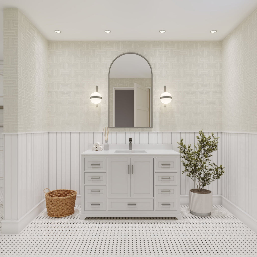 48-inch solid wood bathroom vanity in a stone finish with a white stone countertop and single ceramic sink, brushed metal hardware, arched mirror and sconces, styled with a wicker basket and potted plant.