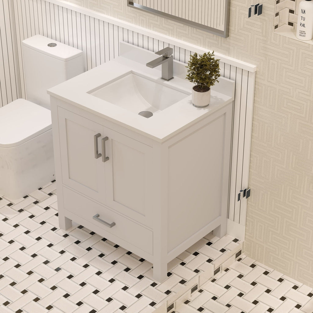 Modern 30-inch freestanding solid wood bathroom vanity in stone finish with a stone top and integrated rectangular ceramic sink, single metal faucet, two doors and a lower drawer with metal handles on black-and-white tile.