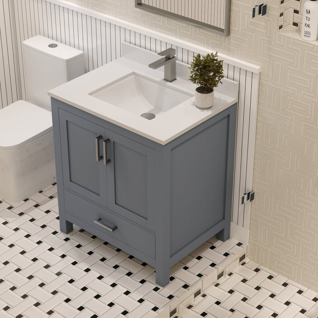 Freestanding modern 30-inch solid wood bathroom vanity in stone-gray with a white stone top and integrated rectangular sink, two-door cabinet and bottom drawer with metal handles shown on patterned tile.