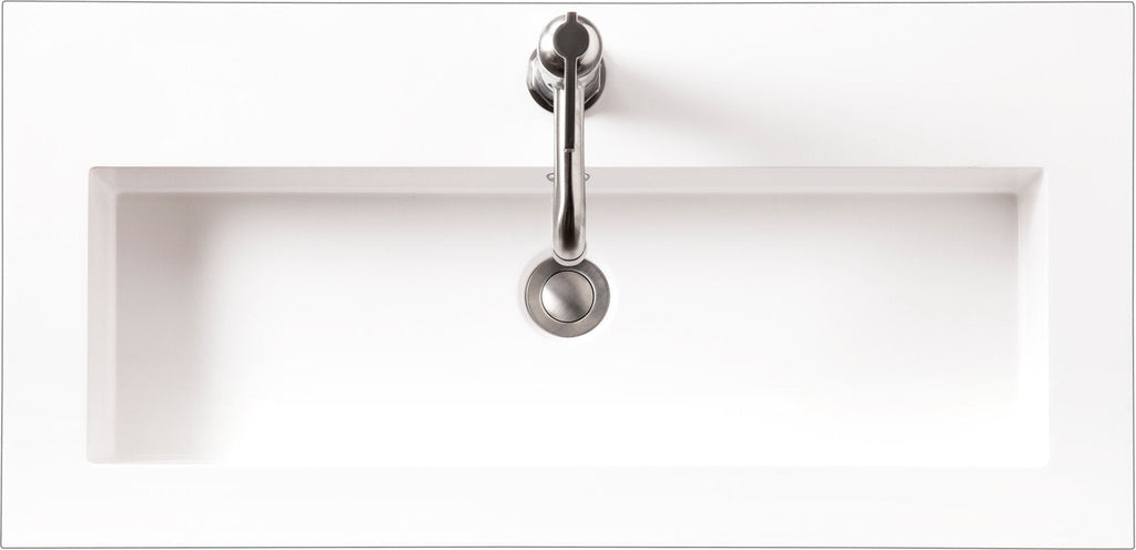 Top-down view of a rectangular white ceramic sink integrated into a stone vanity top, with a centered single-handle stainless faucet and round pop-up drain in a modern bathroom vanity.