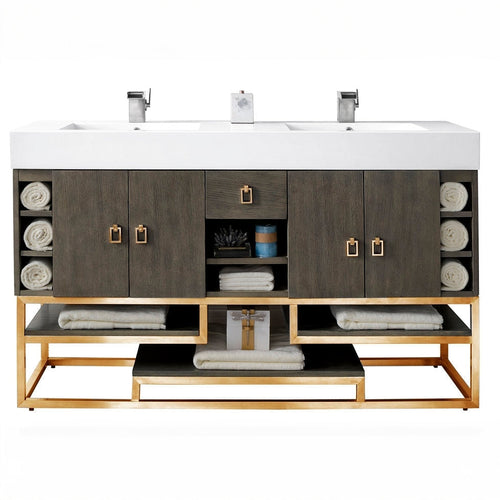 59-inch freestanding double-sink bathroom vanity with a white stone composite top and integrated rectangular sinks, stone-colored solid wood cabinet, gold metal base and square gold pulls, open shelves with rolled towels.