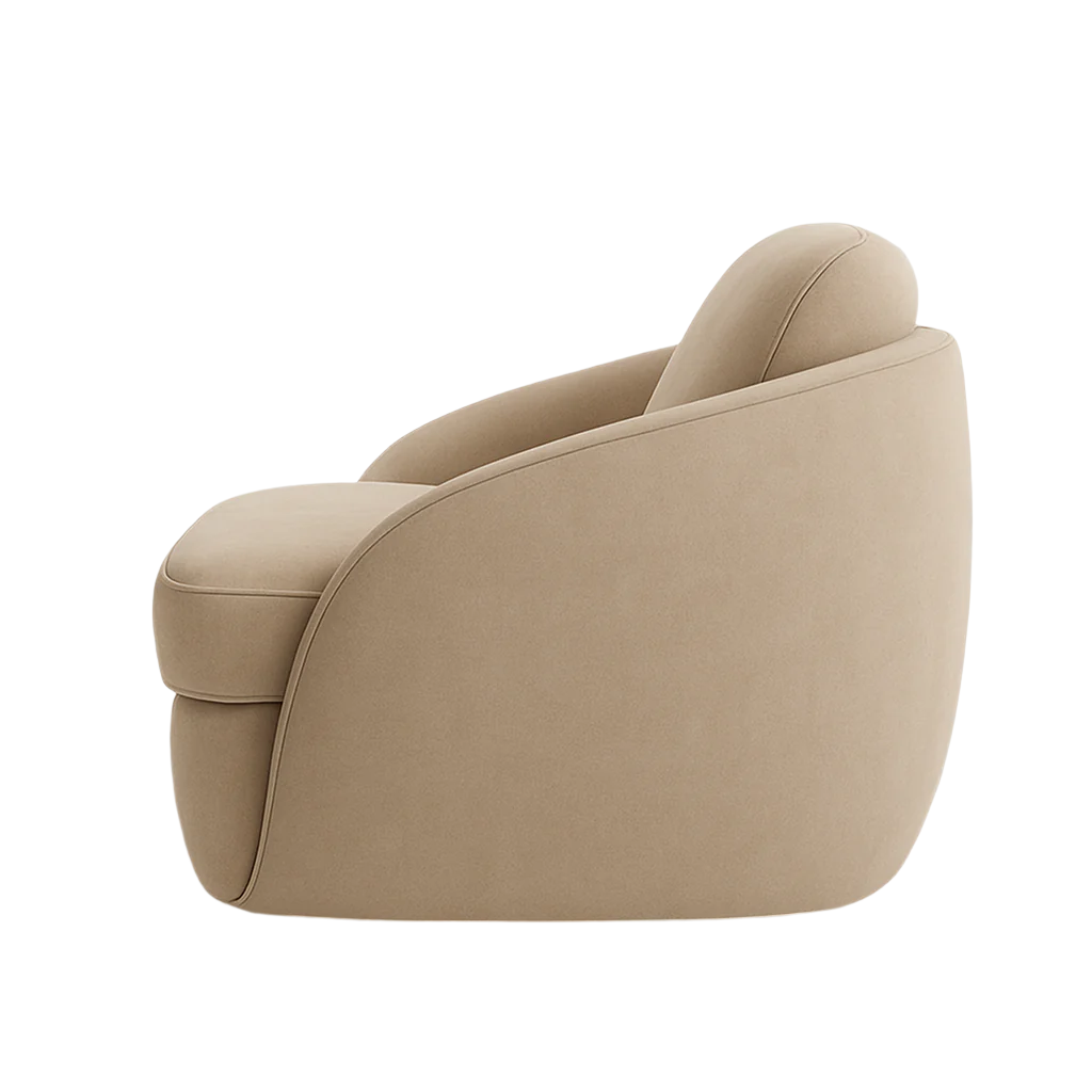 Side view of a modern beige fabric accent chair with a smooth curved silhouette, integrated low arms, plush padded seat and rounded back upholstery.