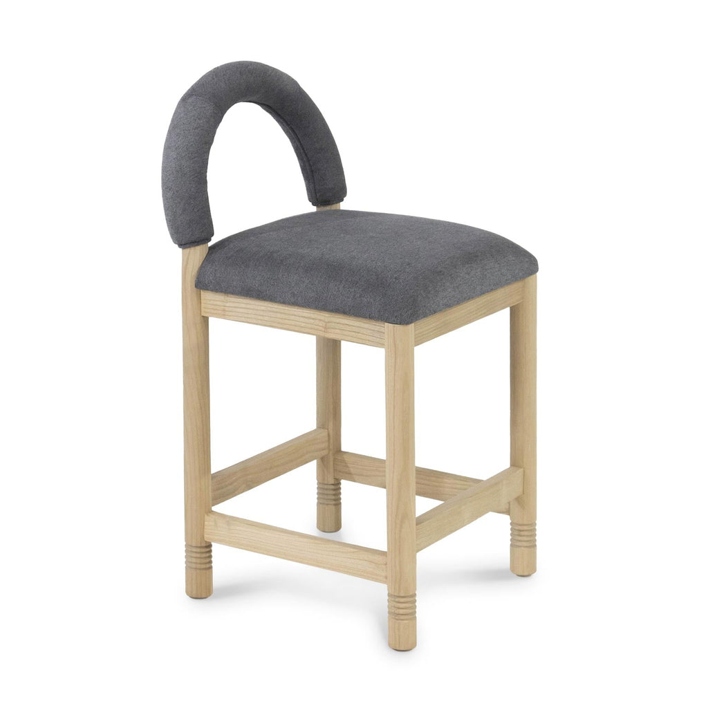 Counter-height stool with a natural oak frame and cushioned seat upholstered in charcoal-gray bouclé, featuring a low padded arched back and supportive stretcher footrests in a contemporary coastal style.