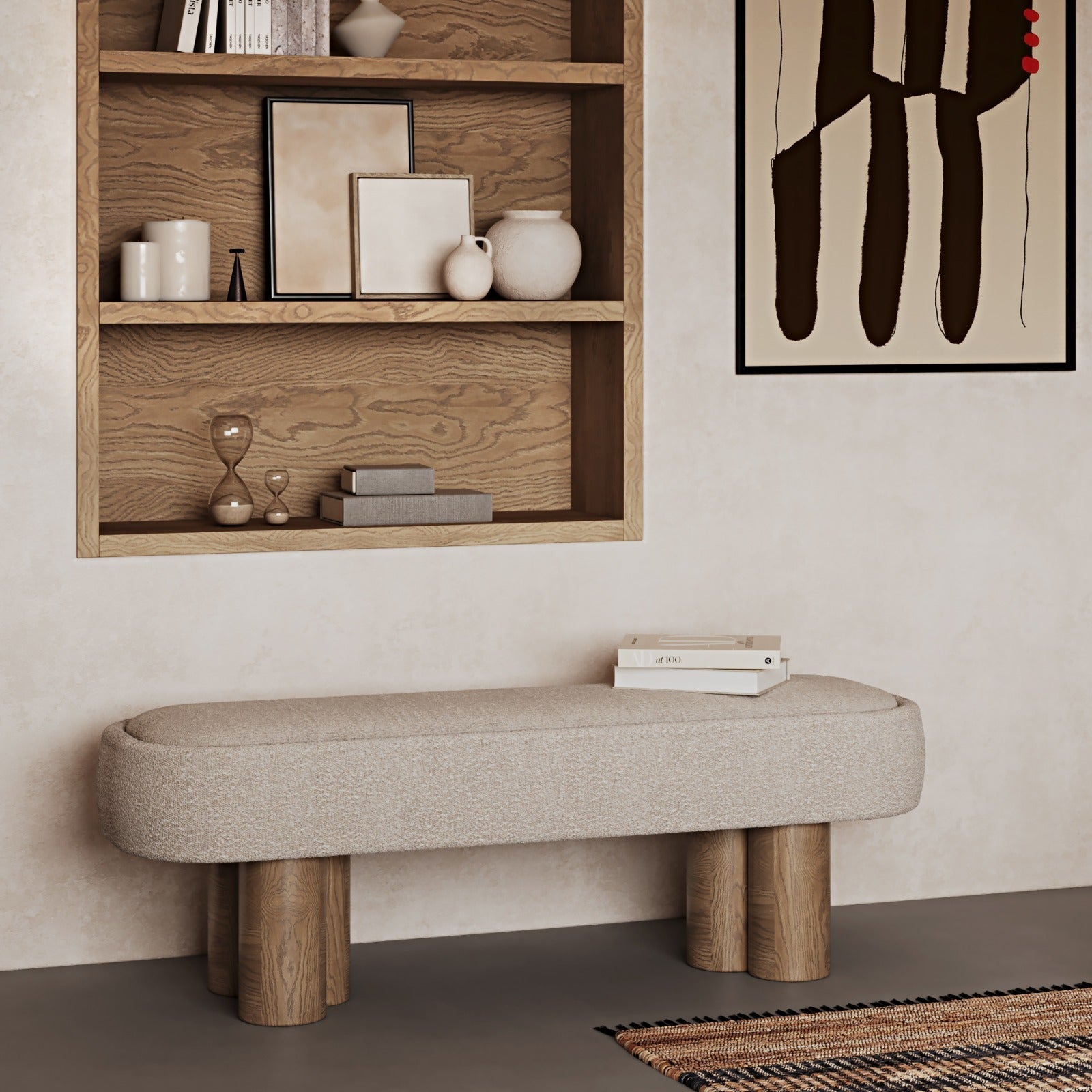 Natural boucle-upholstered bench with rounded rectangular seat and four cylindrical natural wood legs, styled beneath a built-in wooden shelf with ceramic decor, books and a framed abstract print on a neutral wall.