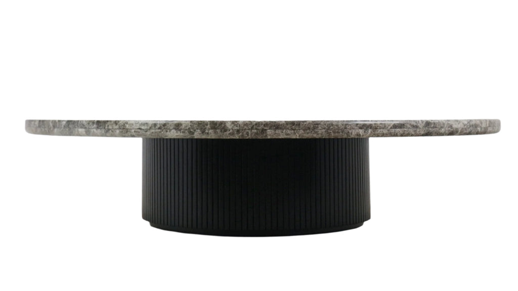Low round coffee table with a grey veined marble top and a black fluted wooden cylindrical base, shown in profile against a white background.
