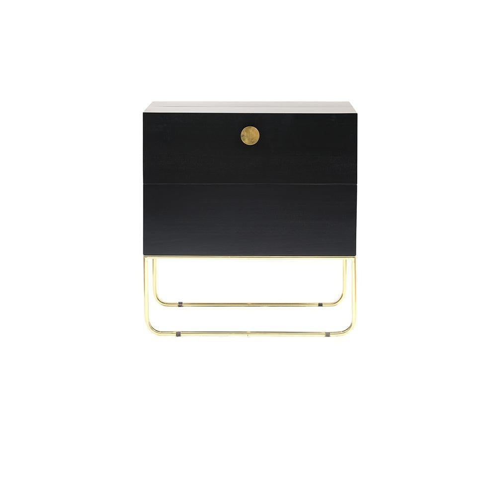 Front view of a mahogany drinks cabinet with a centered round brass knob, two stacked drawers and a polished brass sled-style base in a contemporary glam silhouette on a white background.