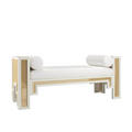 White upholstered end-of-bed bench with a solid wood frame and natural rattan cane panels, featuring a cushioned rectangular seat and two white cylindrical bolster pillows in a boho-contemporary style.