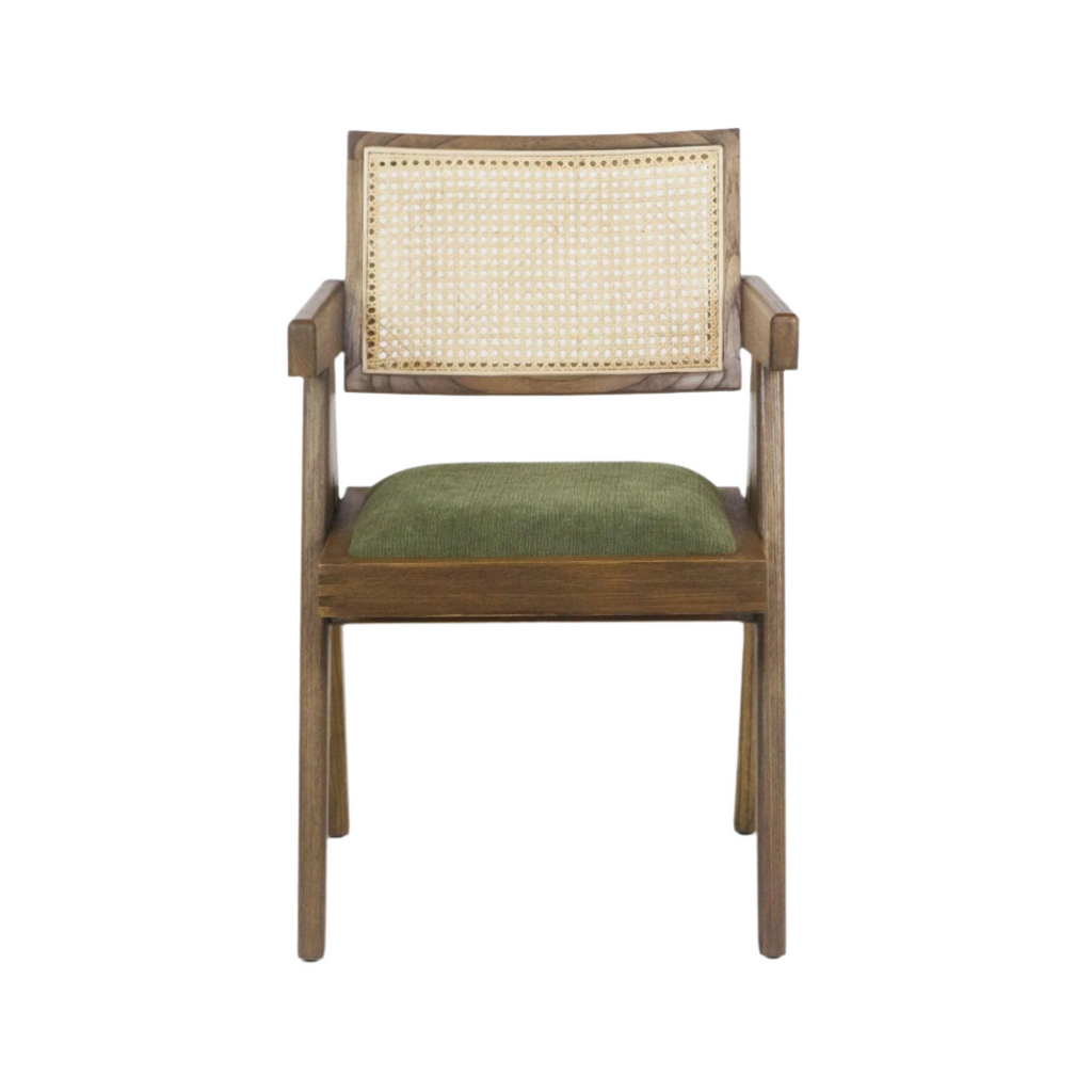 Natural wood dining chair with a woven cane back, square armrests, and a green upholstered seat cushion in a modern mid-century silhouette.