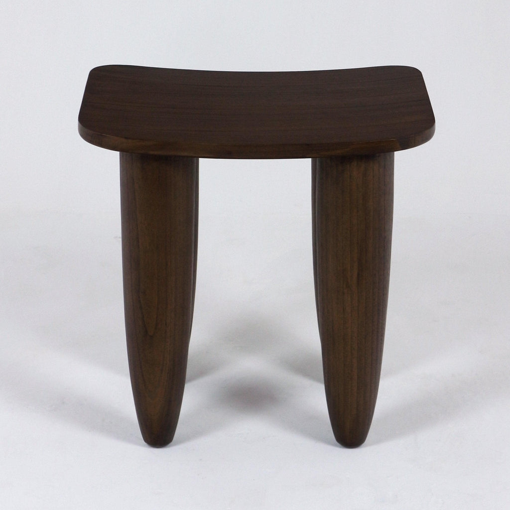Dark mahogany solid wood side table in a modern minimalist style, with a gently curved rectangular top supported by two thick tapered rounded legs on a white background.