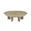 Low round coffee table in natural blonde oak with a woven cane top divided into radial panels around a carved central hub, supported by short solid oak legs for a modern, mid‑century look.