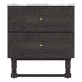Front view of a black wooden two-drawer nightstand with a white marble top, framed drawer fronts, centered round gold knobs, and turned legs connected by a stretcher.
