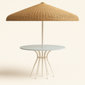 Contemporary outdoor round table with a pale blue top and cream aluminum curved legs, centered under a large woven beige wicker umbrella with a matching cream pole.
