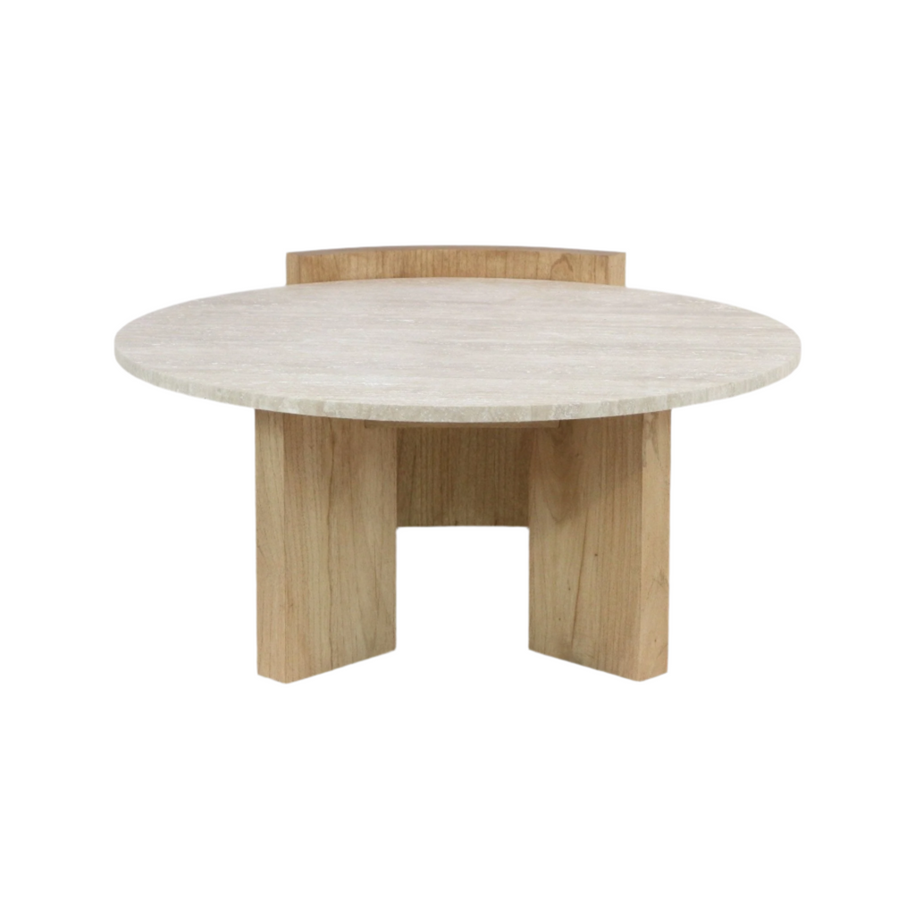 Round travertine stone coffee table top in a pale beige finish set on a natural solid wood base with three wide legs, modern minimalist contemporary design.