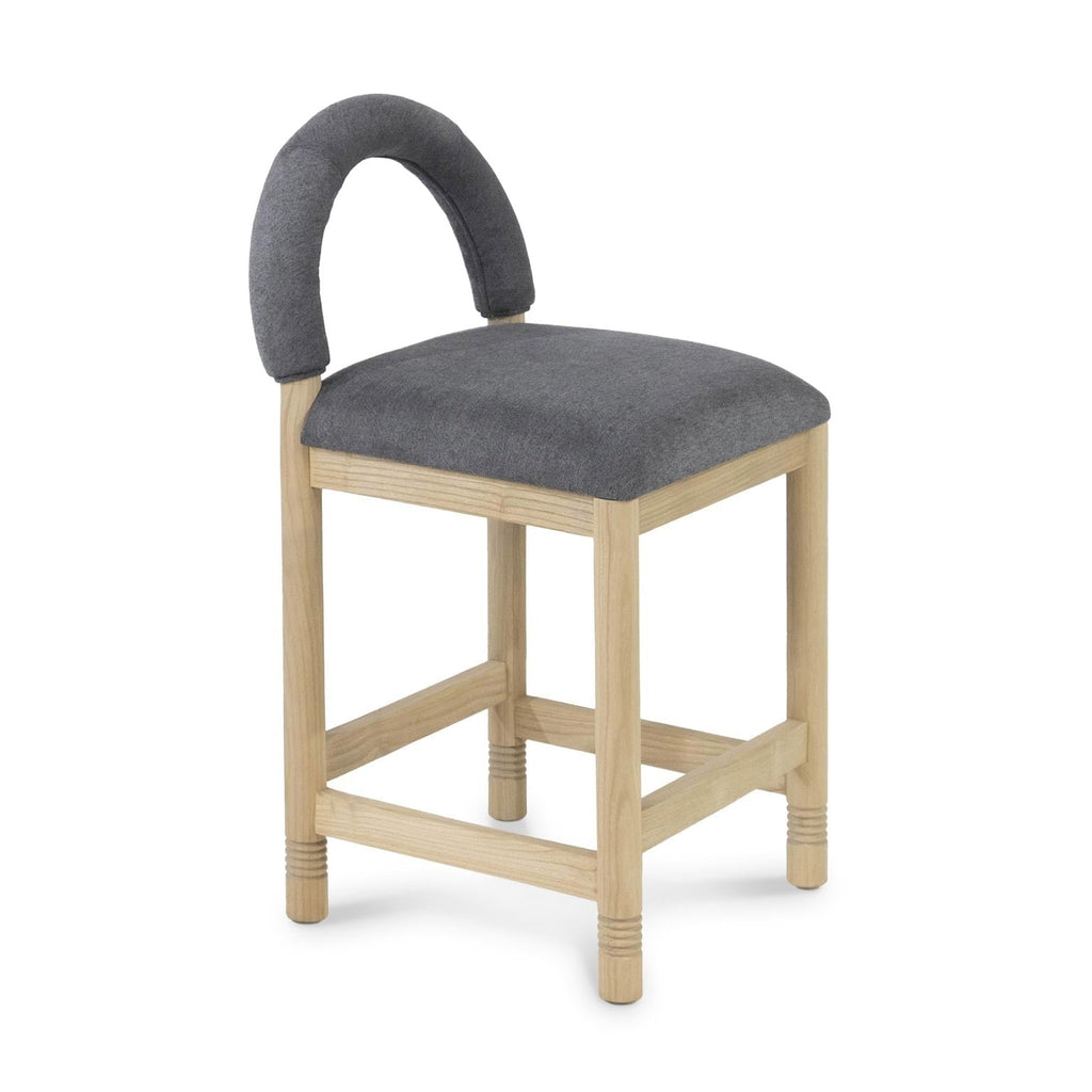 Counter-height stool with a natural oak frame and cushioned seat upholstered in charcoal-gray bouclé, featuring a low padded arched back and supportive stretcher footrests in a contemporary coastal style.