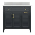 Freestanding solid wood single-sink bathroom vanity in charcoal finish with a white speckled stone countertop and integrated basin, featuring louvered cabinet doors and brass drawer pulls and handles.