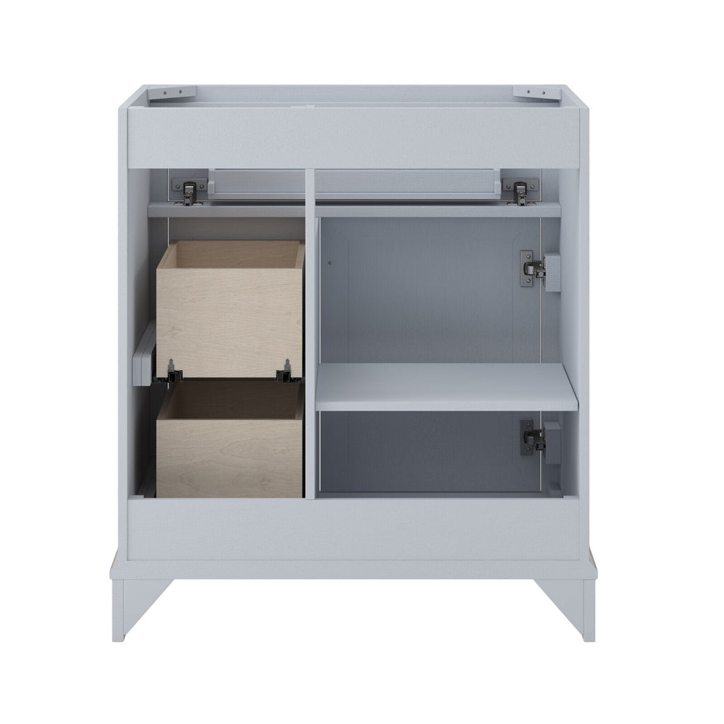 Interior view of a white solid wood 31-inch single-sink bathroom vanity showing two natural wood pull-out drawers on the left, an adjustable shelf and soft-close hinges on the right, plus a freestanding base.