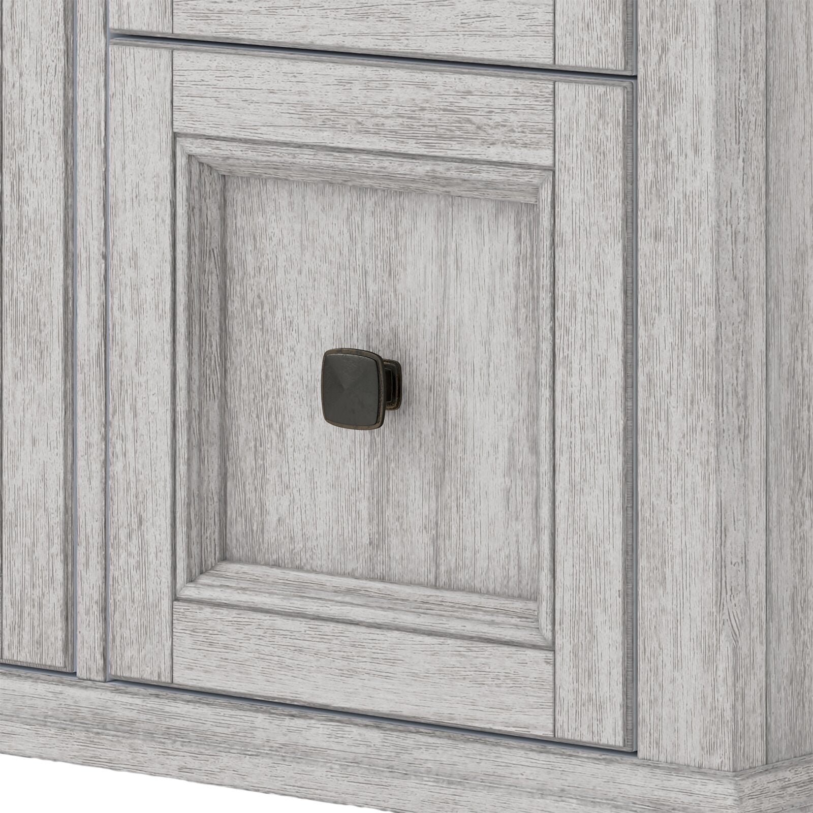 Close-up of a stone gray solid wood bathroom vanity door with recessed paneling and a dark square metal knob, highlighting the wood grain texture and contemporary distressed finish.